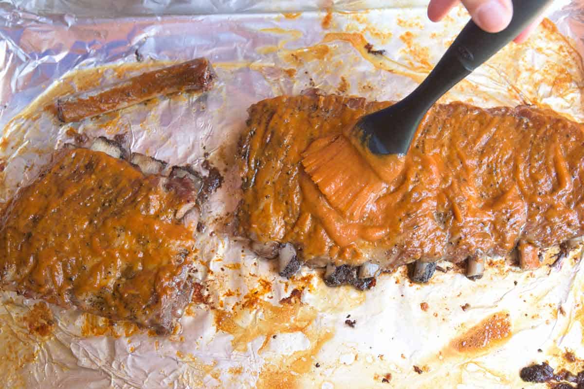 Bacon Bourbon Oven Baked Ribs Adding the Barbecue Sauce