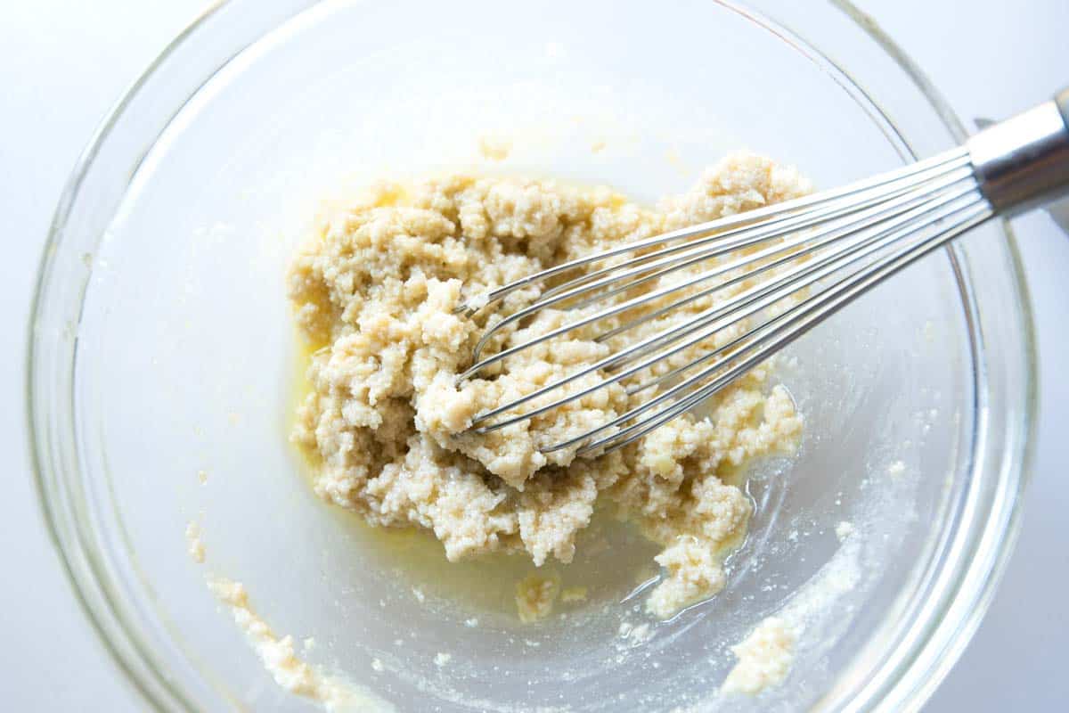 Making tahini sauce showing how its lumpy before adding water.