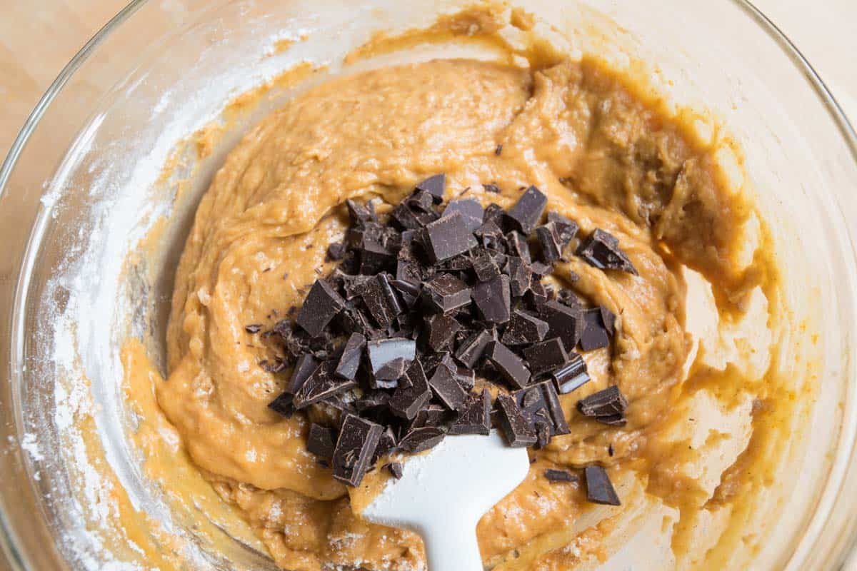 Adding the chocolate chunks to the pumpkin batter