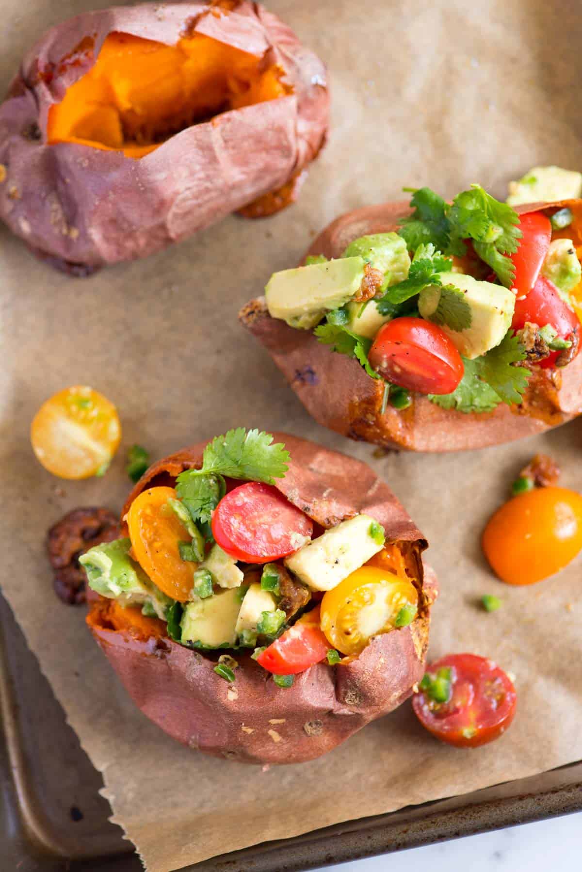 Baked sweet potatoes stuffed with roasted garlic, avocado and tomato salsa (delicious, vegetarian and vegan).