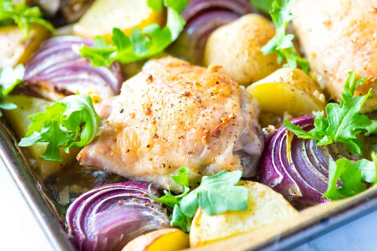 Garlic baked chicken thighs and potatoes on a sheet pan