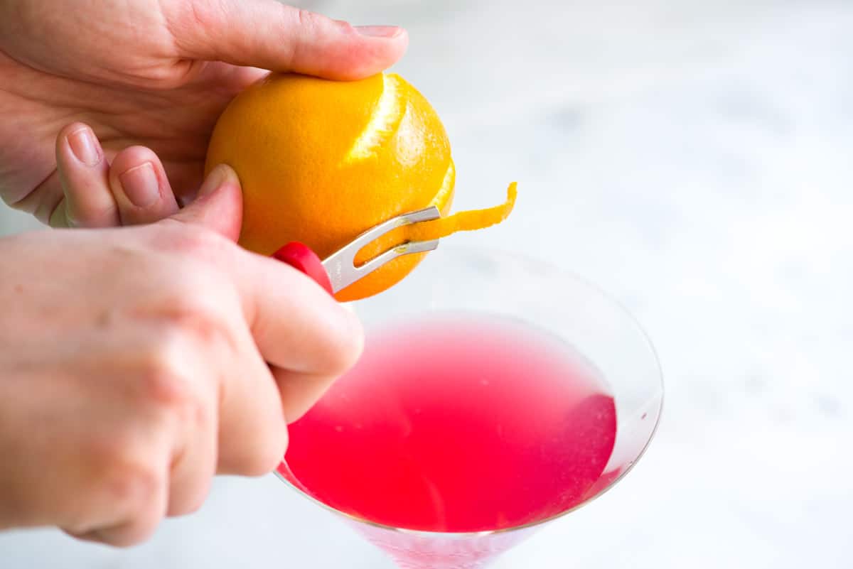 Garnishing a perfect cosmopolitan cocktail