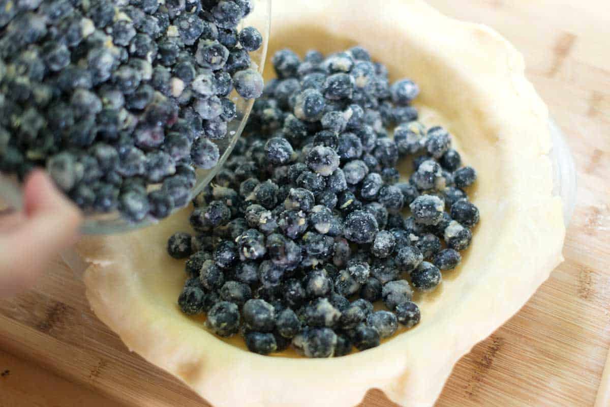 Adding blueberry pie filling to pie crust for homemade blueberry pie
