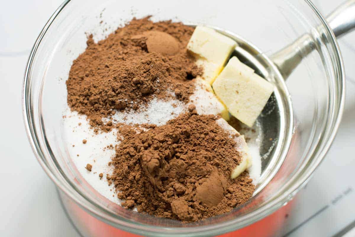 Melting the butter with sugar, cocoa powder, and salt.