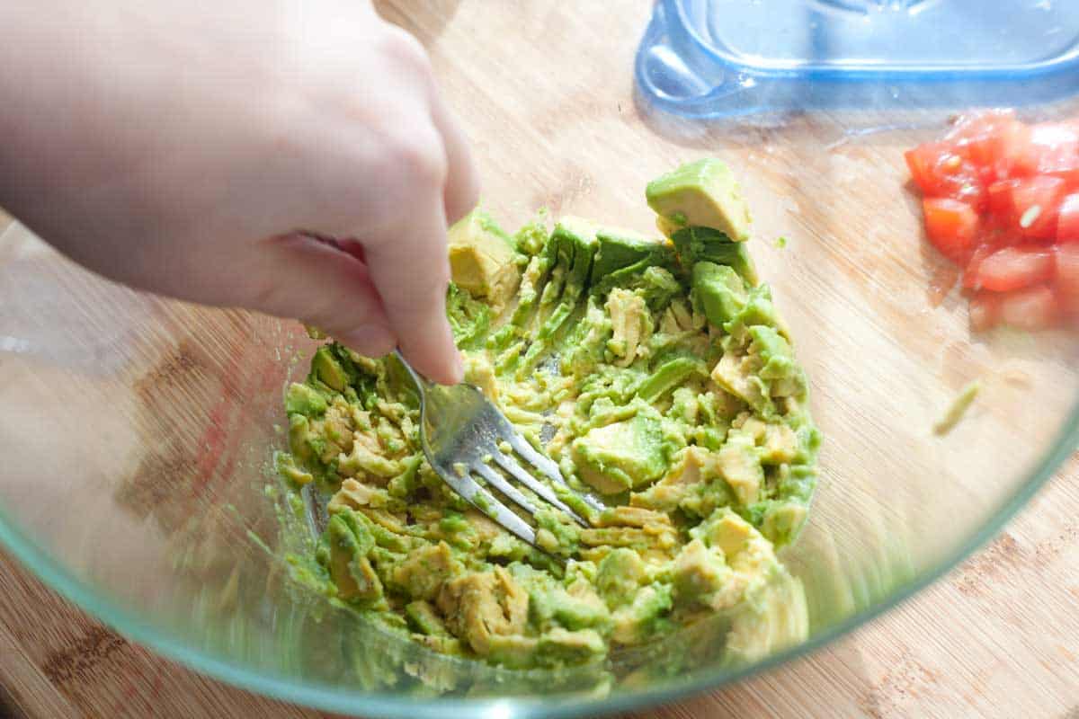 Mashing avocado for pasta sauce