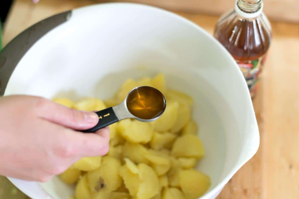 Tossing potatoes with vinegar