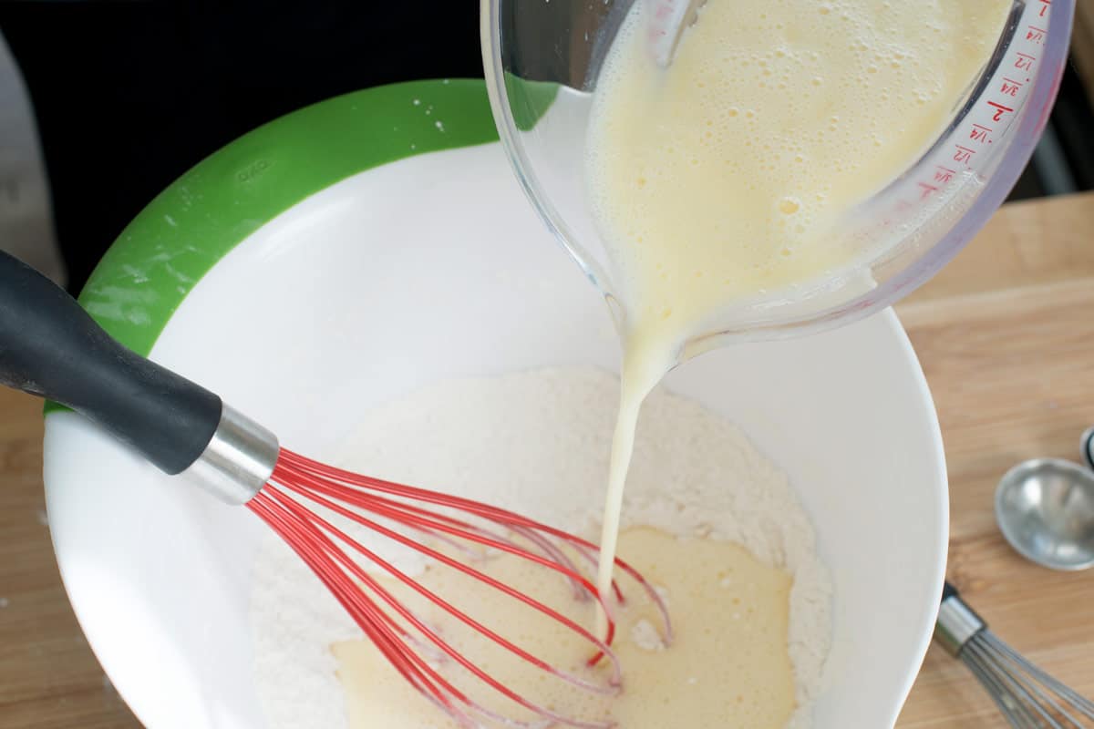 Adding the wet ingredients to make the waffle batter