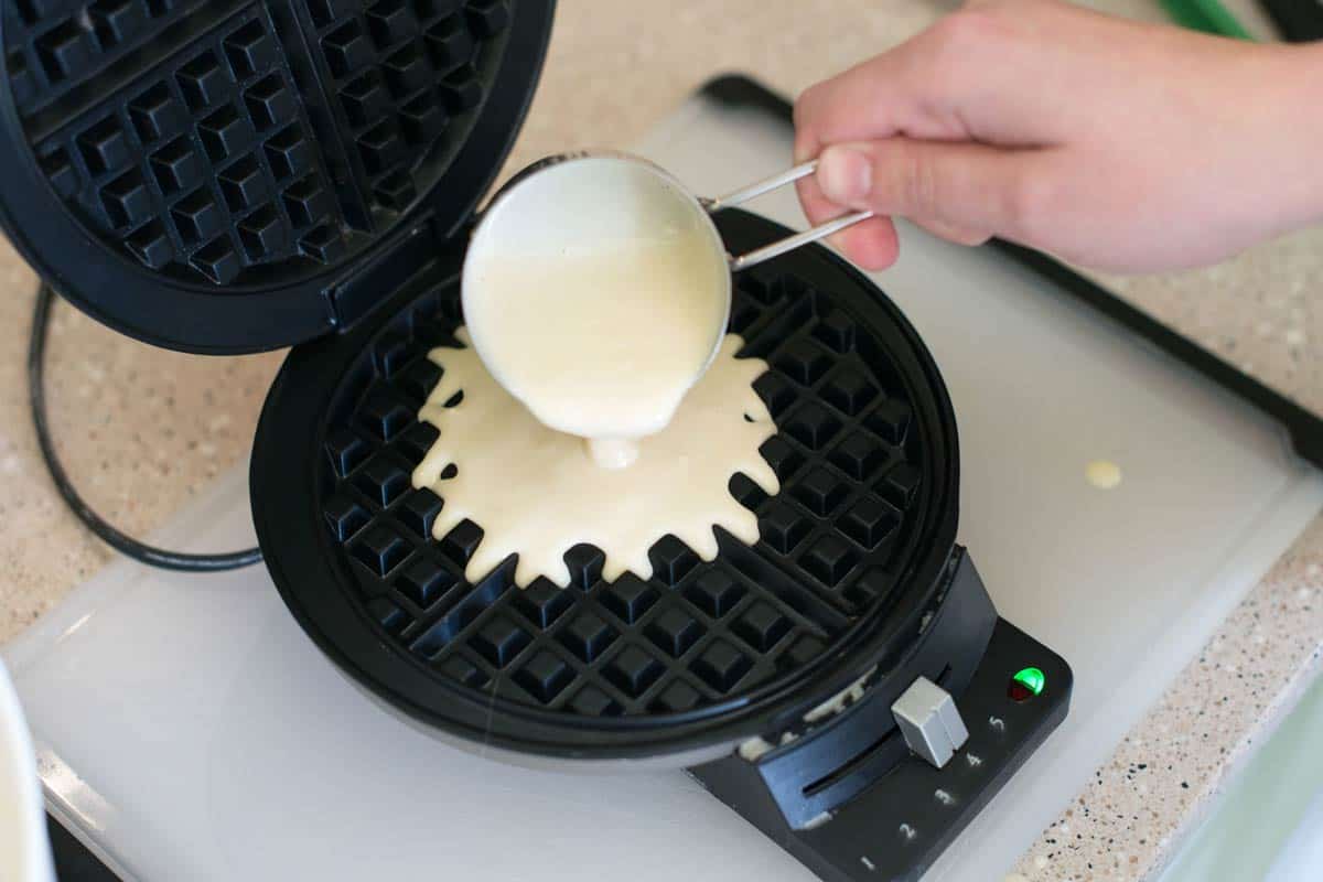 Pouring waffle batter on to a regular waffle iron