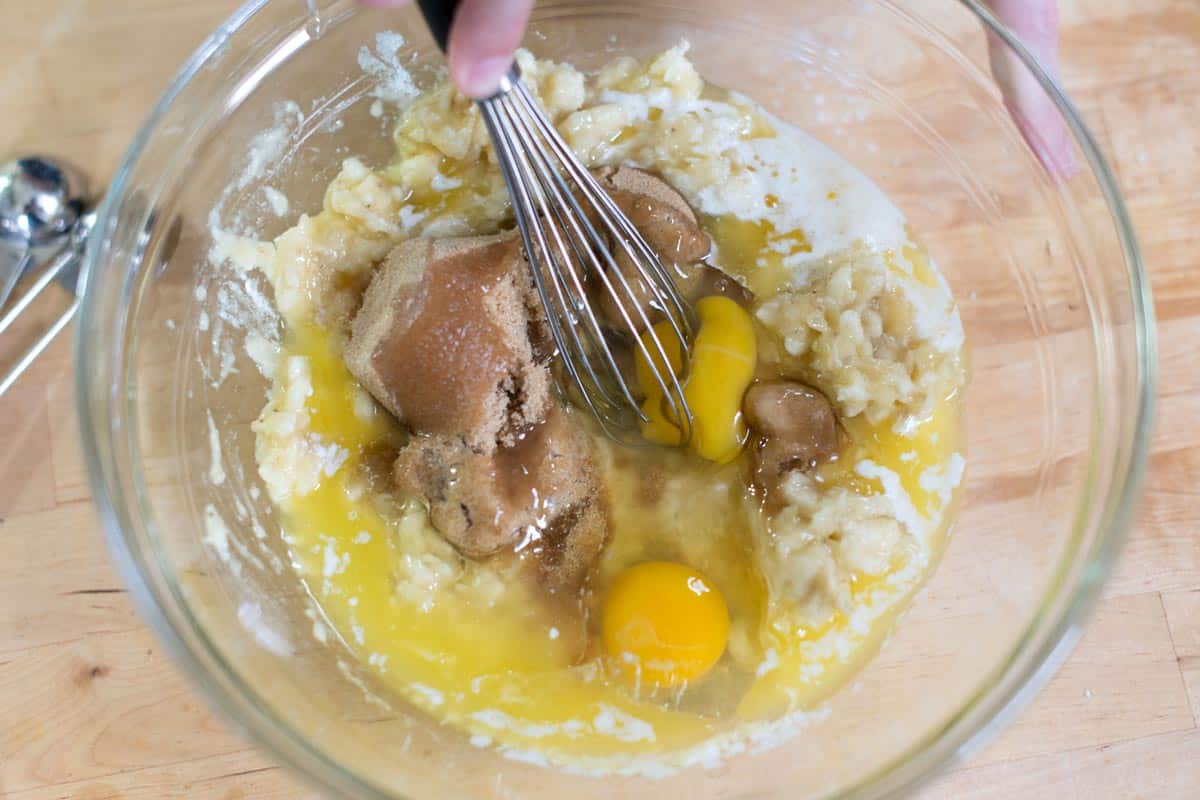 Whisking banana bread ingredients (Mashed Bananas, Flour, Baking Soda, Butter, Brown Sugar, Eggs)