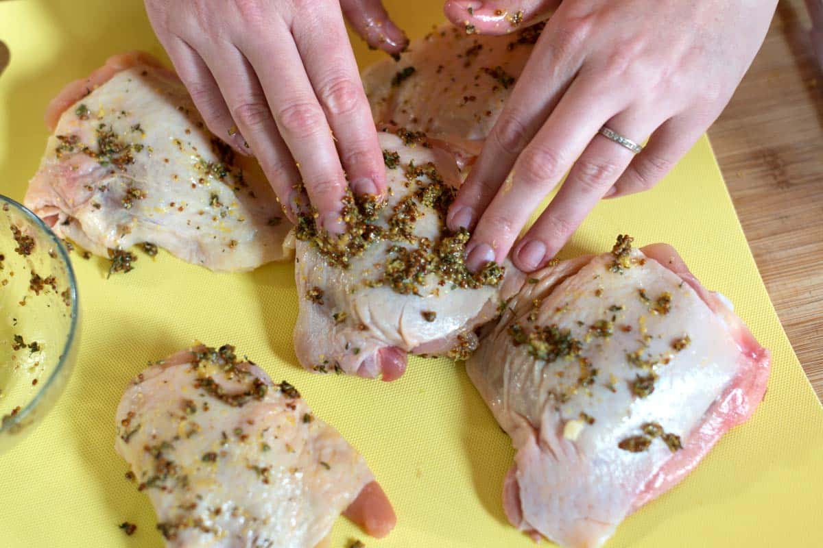 Rubbing chicken thighs with a lemon mustard rub for one of my favorite chicken thighs recipes.