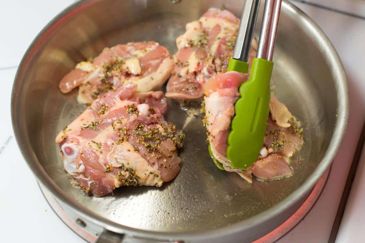 Searing chicken thighs, skin-side-down for golden brown skin