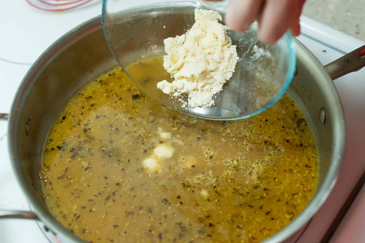 Thickening the lemon gravy to serve with our chicken thighs.