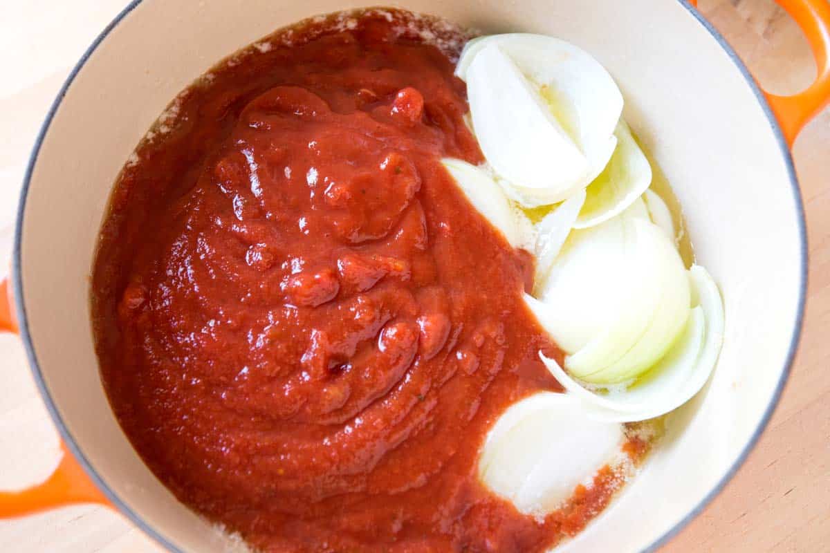 Tomato Soup Ingredients in a pot (canned tomatoes, butter, and onion)