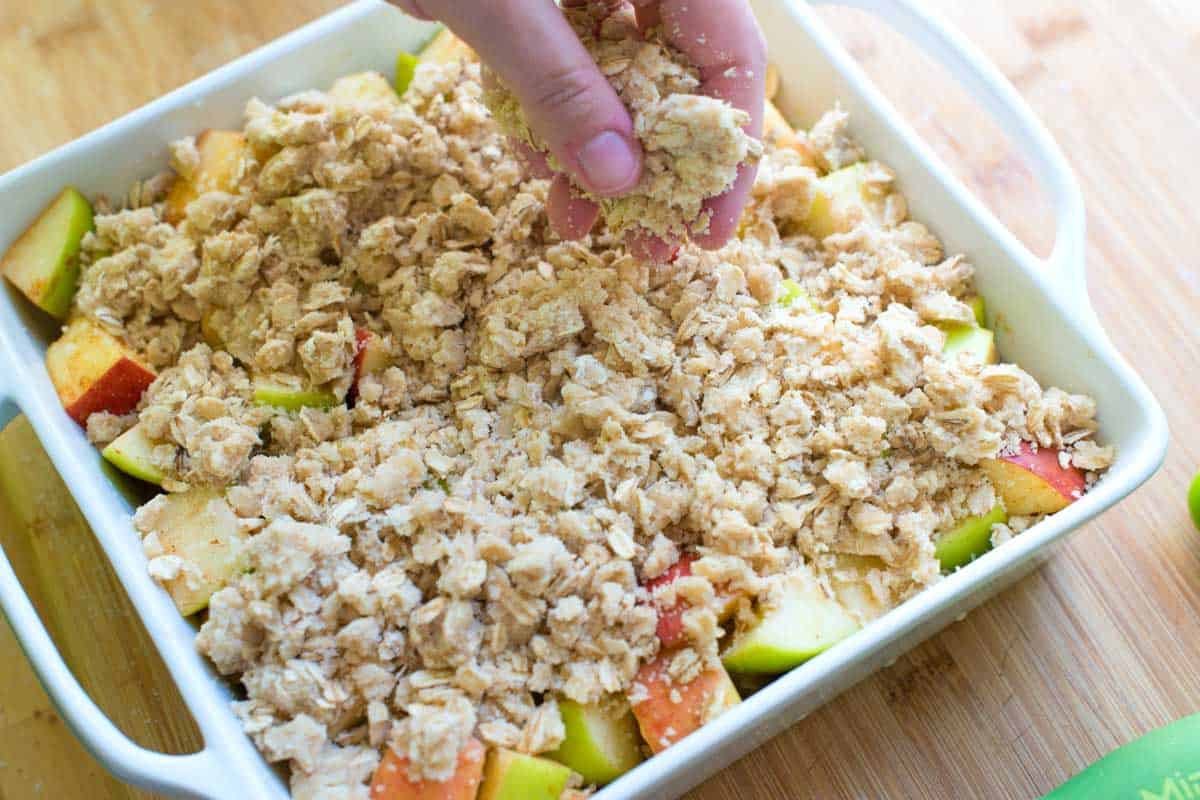 Adding the oat topping to the apples