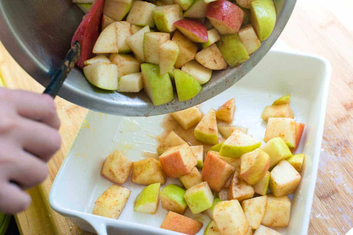 How to Make Apple Crisp - Adding the spiced apples to the baking dish