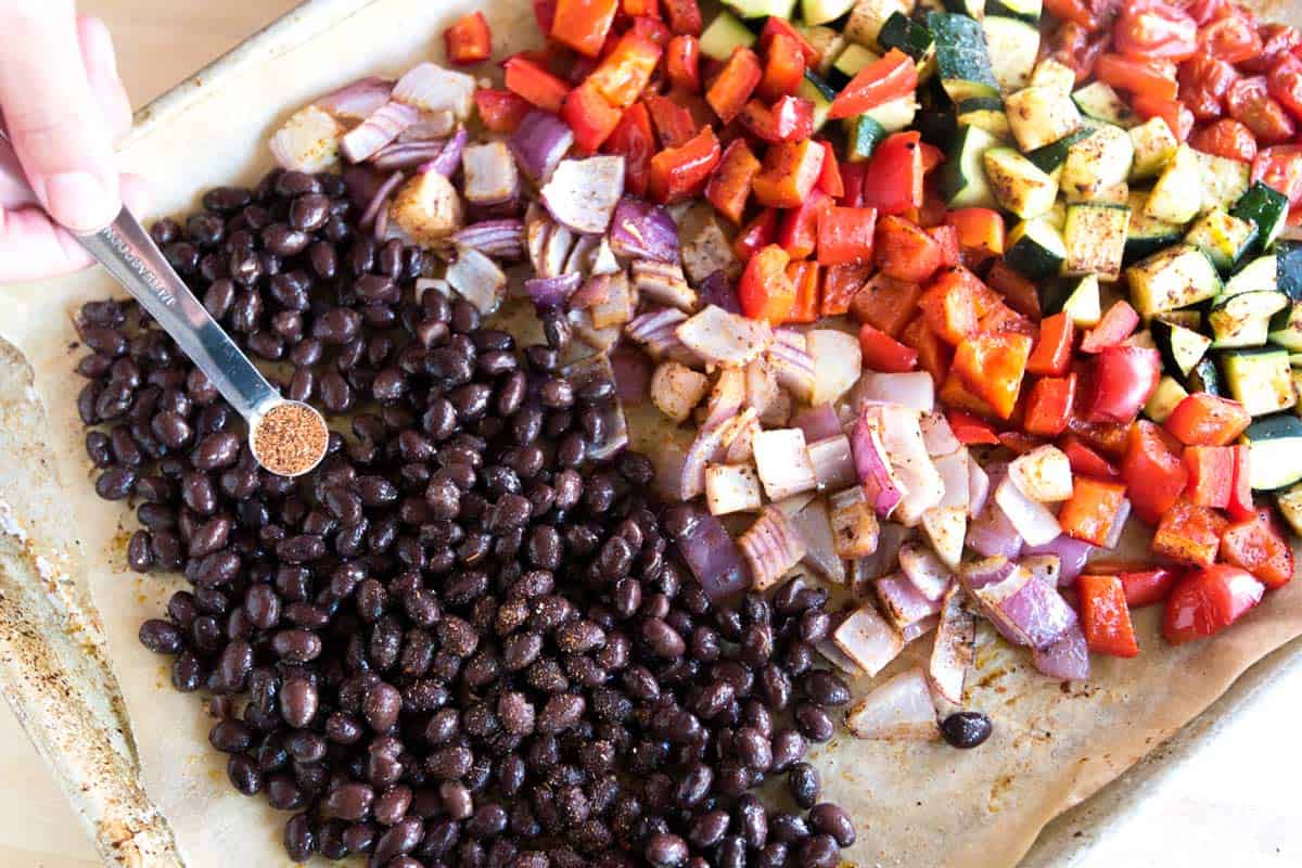 adding cooked (or canned) black beans tossed with some chili powder to the baking sheet with veggies