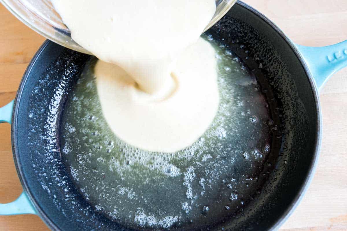 Pour the batter into a hot skillet with melted butter.
