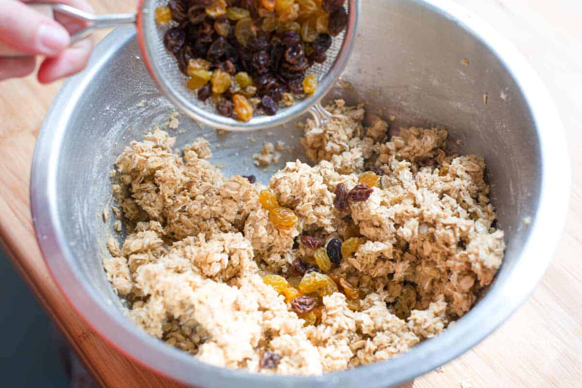 Adding the plumped raisins to the oatmeal cookie batter