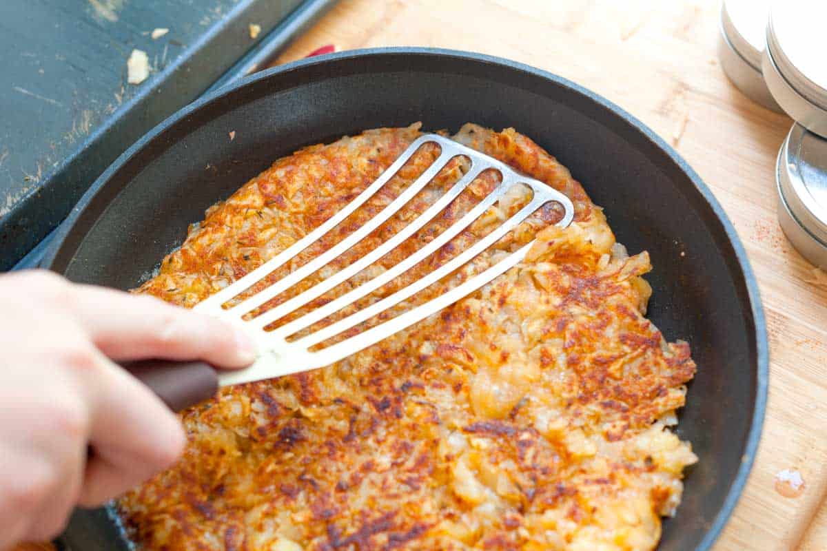Crispy Spiced Potato Pancakes How to Make Potato Pancakes: Pressing the pancake back together after flipping