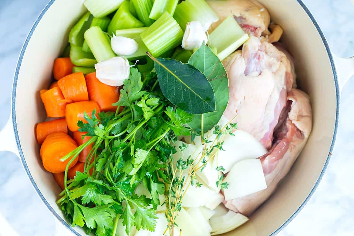 This homemade chicken broth will knock out anything you can buy at the store. Use leftover bones or chicken parts. Ingredients for chicken broth / chicken broth in a soup pot