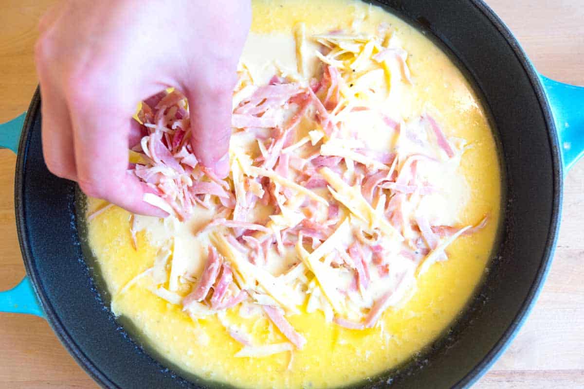 Ham and Cheese Dutch Baby Pancake Recipe How to Make a Ham and Cheese Dutch Baby: Adding the ham and cheese