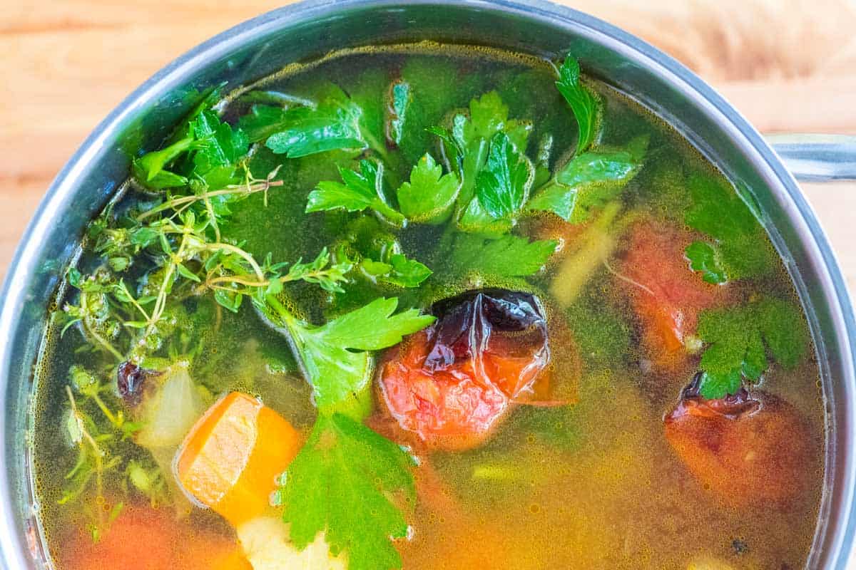 Making veggie broth -- adding tomatoes for extra sweetness and umami.