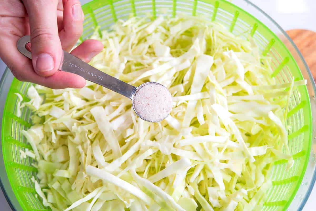 Salting cabbage for the best coleslaw.