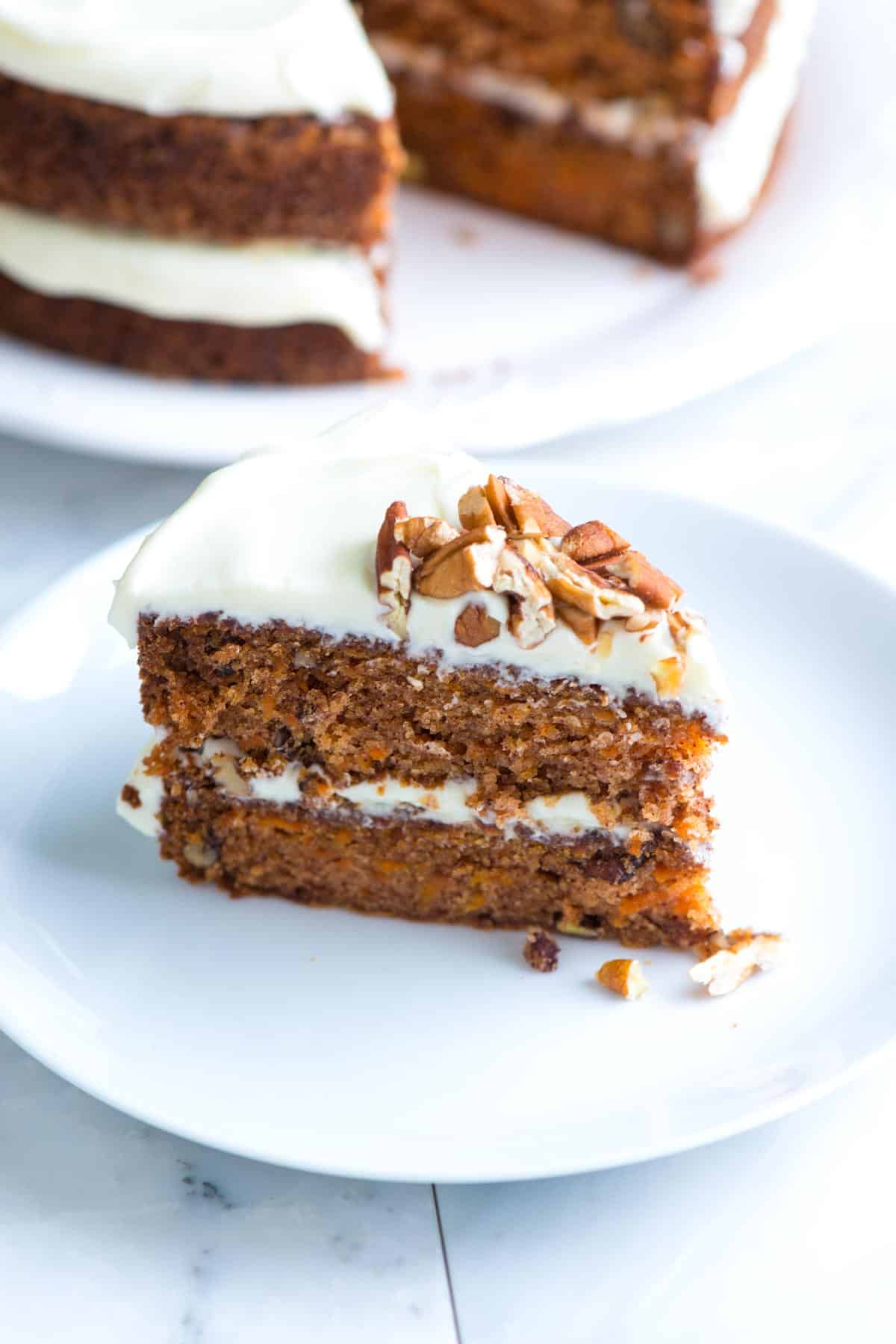 Slice of carrot cake with cream cheese frosting.