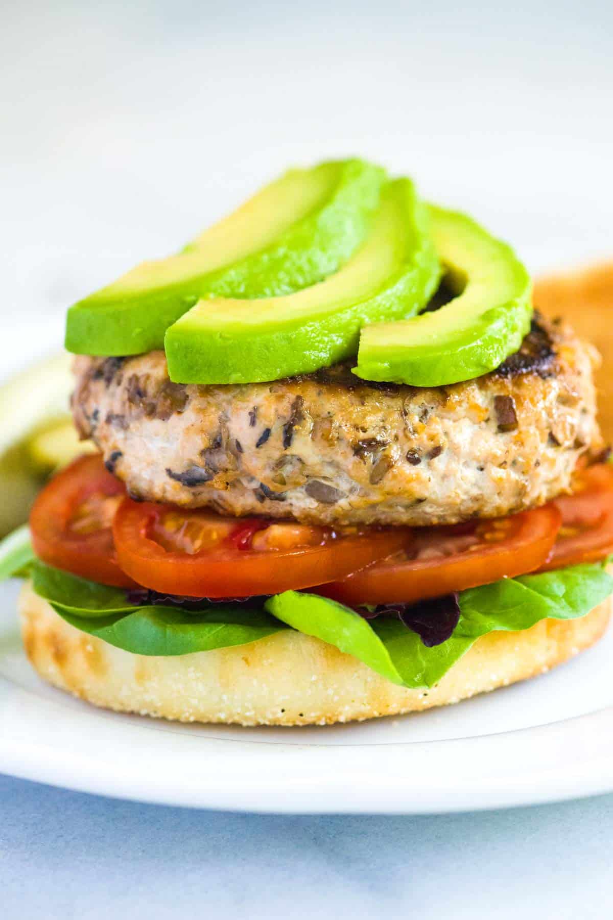 Turkey Burgers topped with avocado