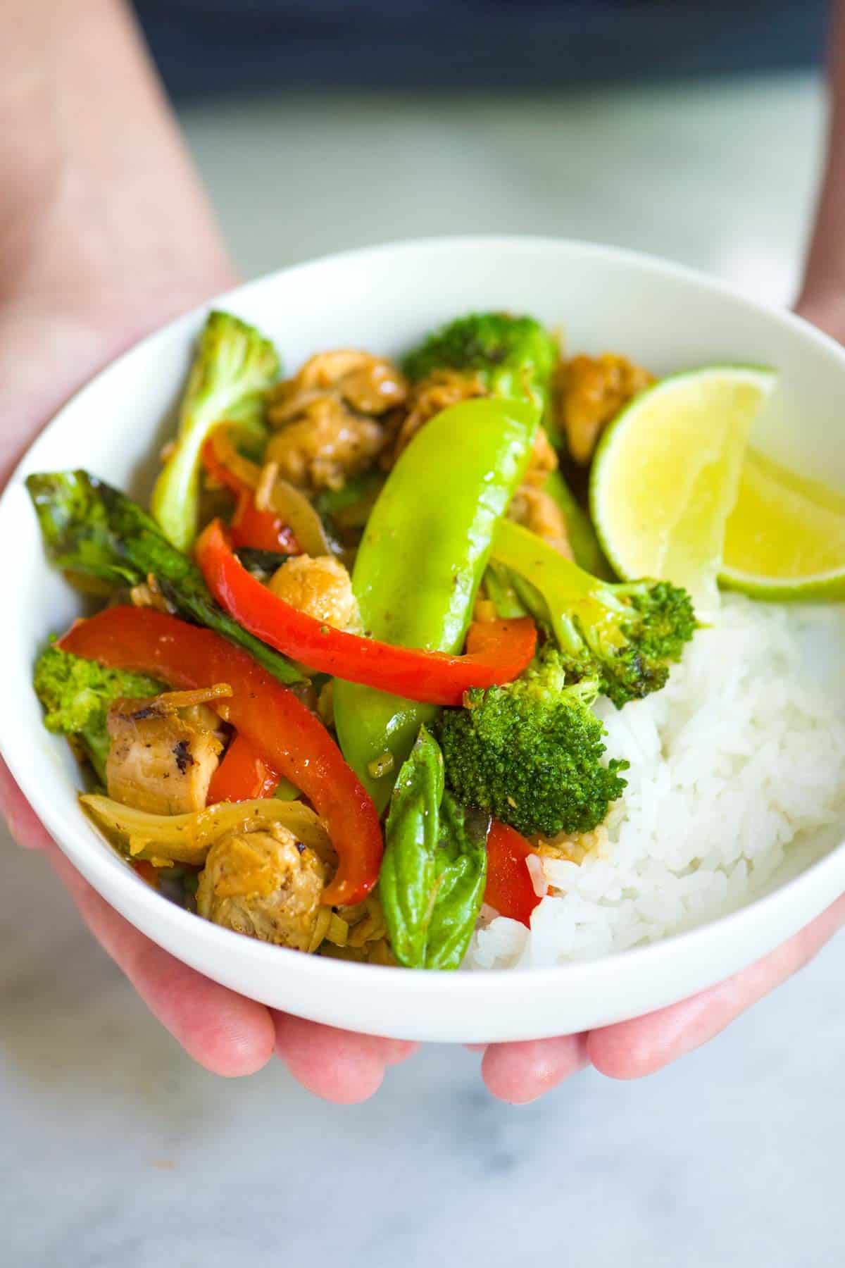 Bowl of chicken stir fry with vegetables and rice