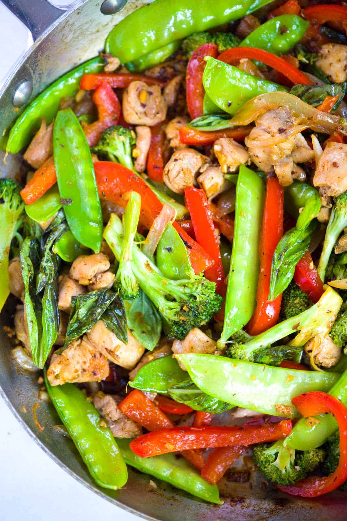 Pan filled with stir fried chicken and vegetables