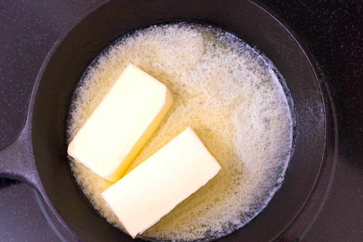 How to make buffalo wing sauce: Melting butter in a skillet over low heat.