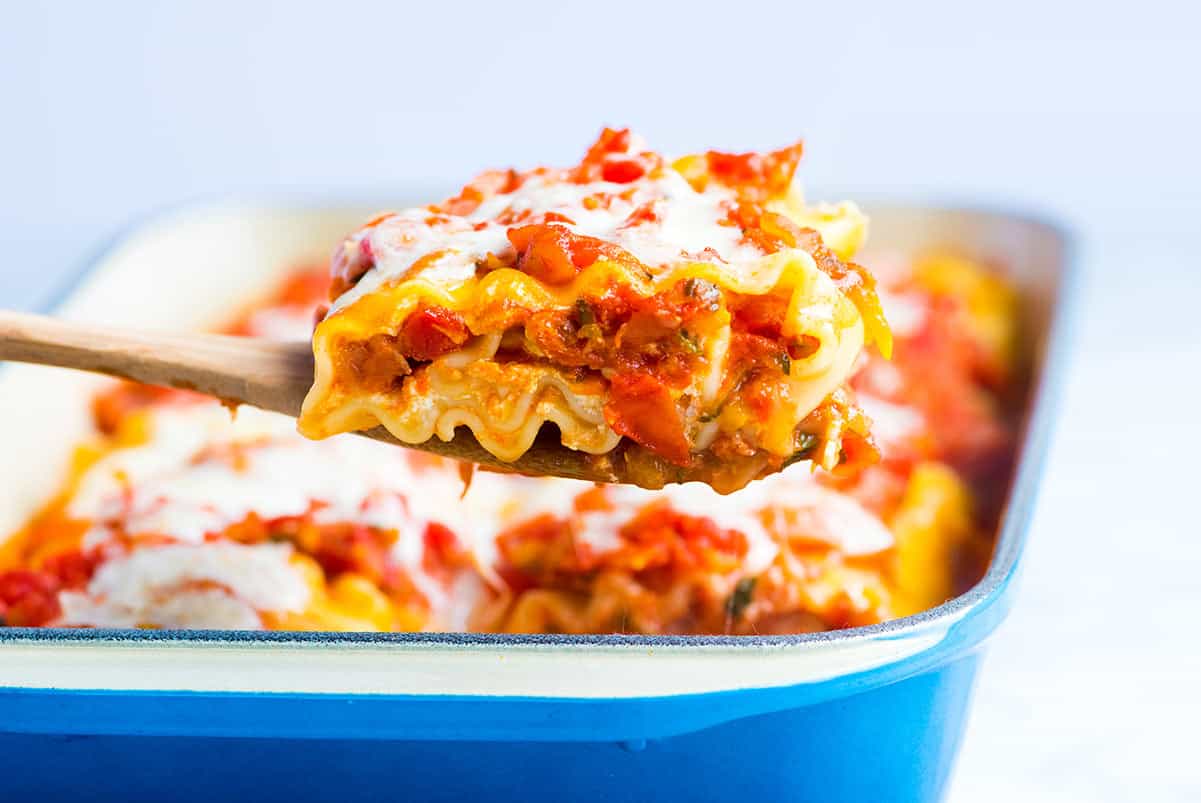 These easy lasagna roll ups with fresh vegetables, a light tomato sauce and cheese are a must make. Make them now or prep and freeze for later.