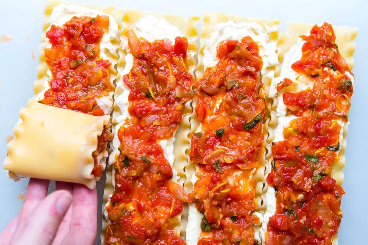 These easy lasagna roll ups with fresh vegetables, a light tomato sauce and cheese are a must make. Make them now or prep and freeze for later. How to roll up lasagna noodles for roll ups.