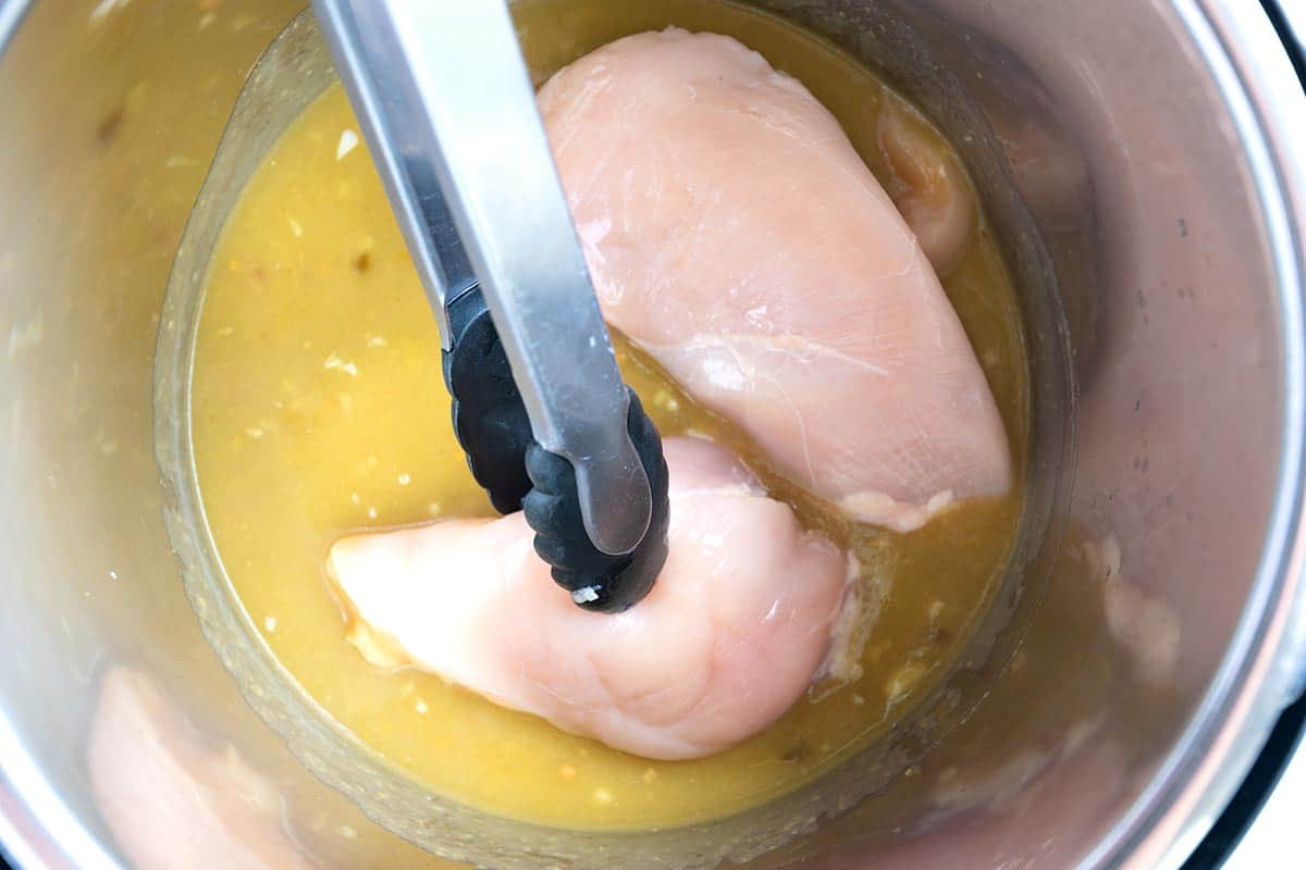 Placing chicken breasts into the Instant Pot