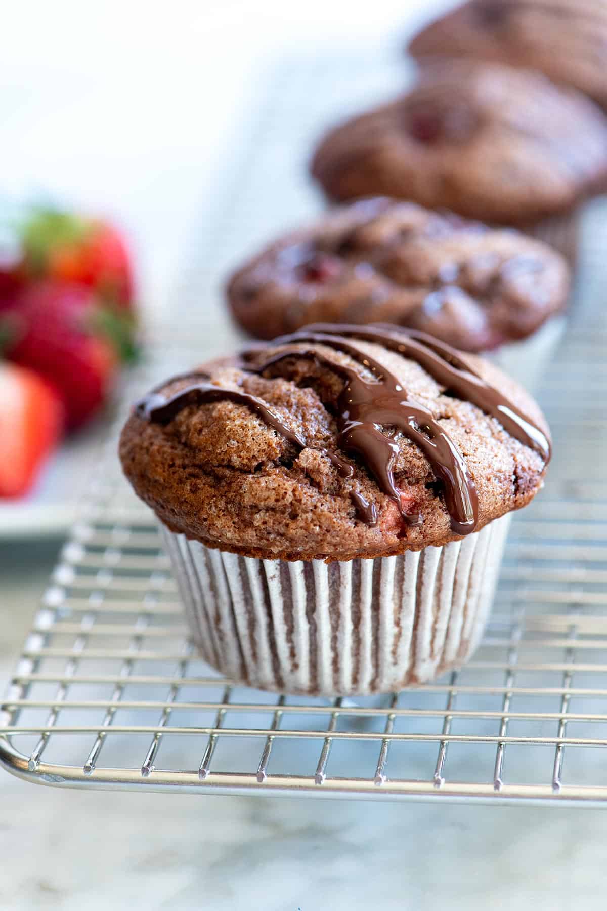 This easy chocolate muffins recipe combines two of our favorite things: fresh strawberries and chocolate! See how to make tender muffins packed with strawberries and topped with a chocolate drizzle. Strawberry Chocolate Muffins