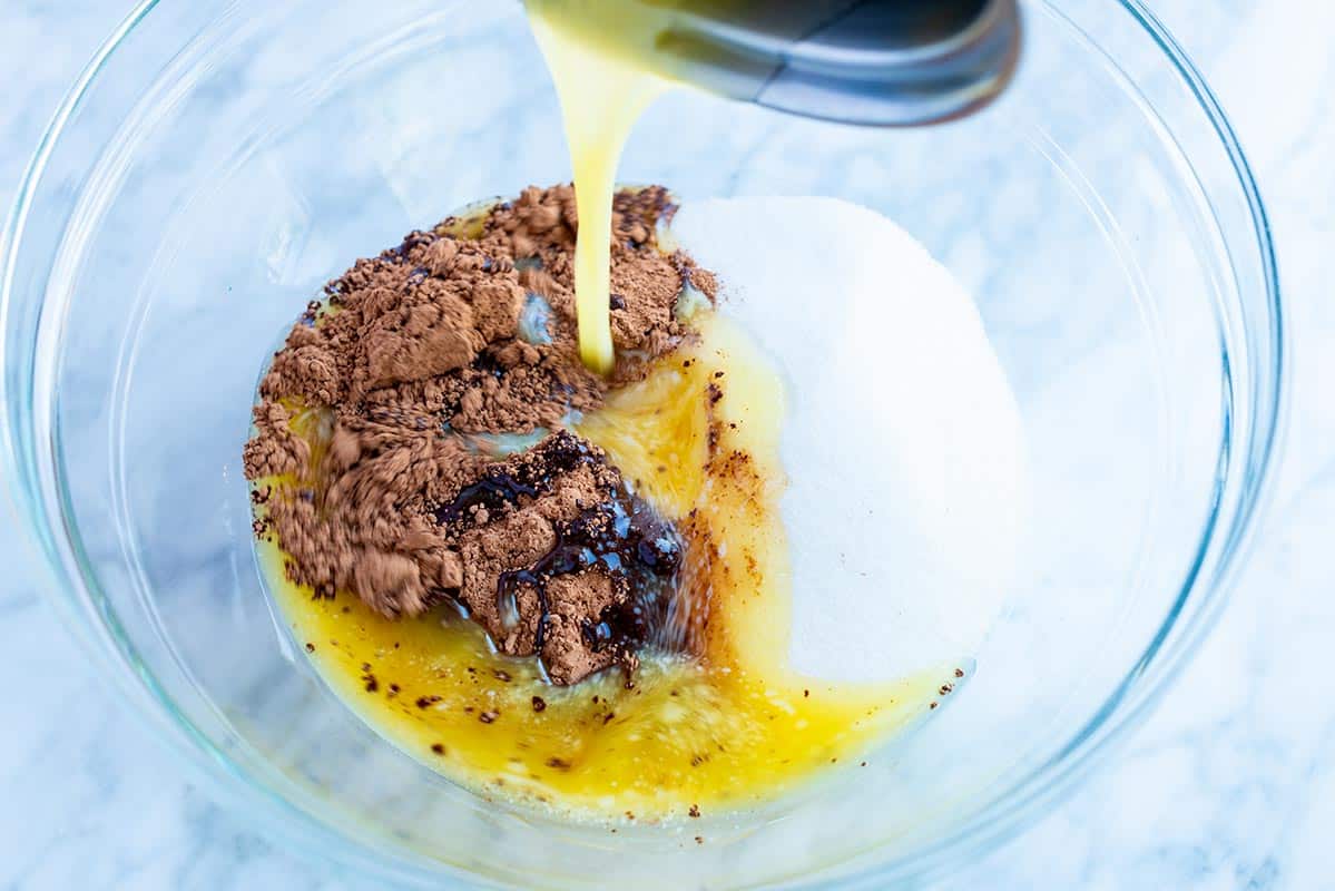 If you combine cocoa powder with a hot liquid it helps to "bloom" the cocoa, which makes the cocoa powder taste even more rich and chocolaty than if you were to just add cocoa to the dry ingredients. Combing ingredients to make batter