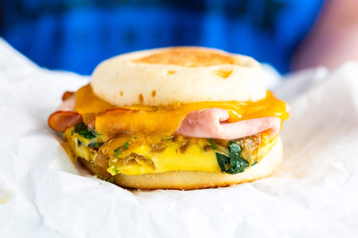 Tasty, satisfying make-ahead breakfast sandwich recipe with veggies and ham (or your favorite meat). Refrigerate for 5 days freeze up to a month.