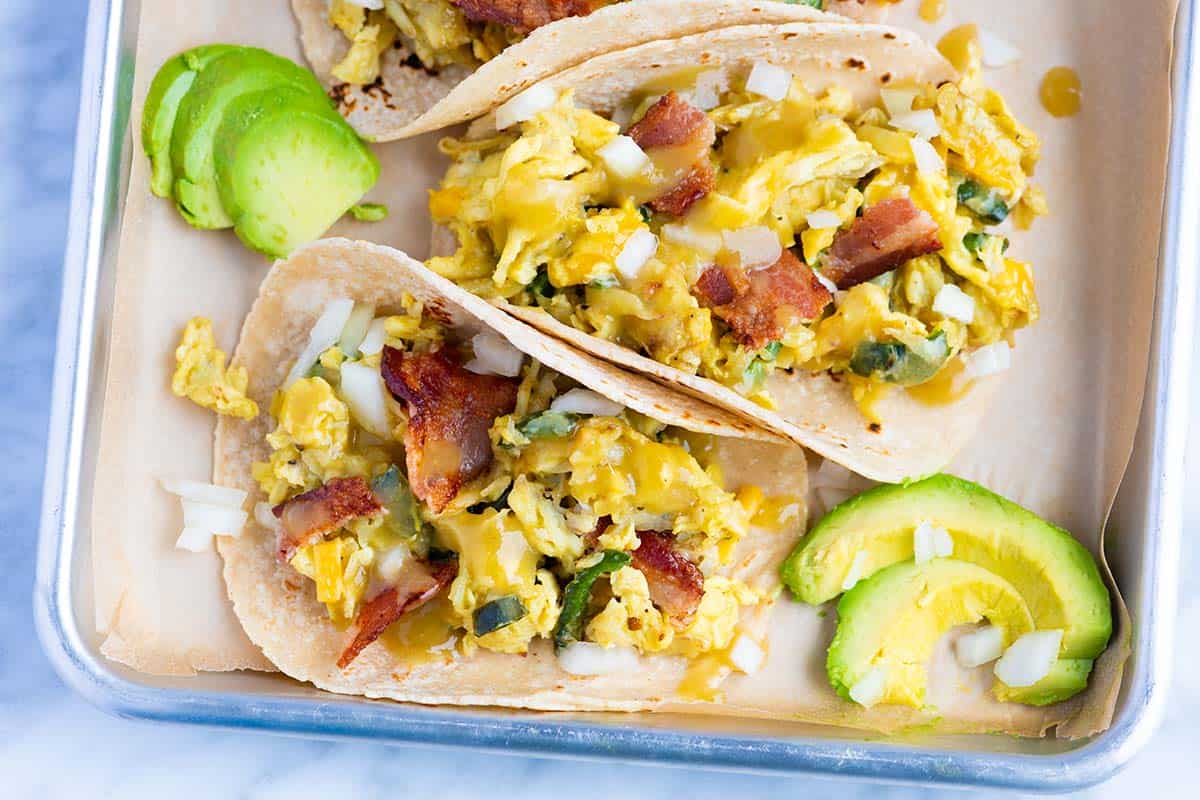 These easy breakfast tacos with shredded potatoes, peppers and onions are ultra-satisfying, quick and delicious. You have just found your new favorite breakfast.