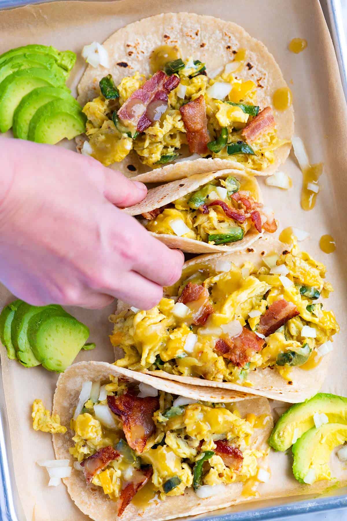 These easy breakfast tacos with shredded potatoes, peppers and onions are ultra-satisfying, quick and delicious. You have just found your new favorite breakfast.