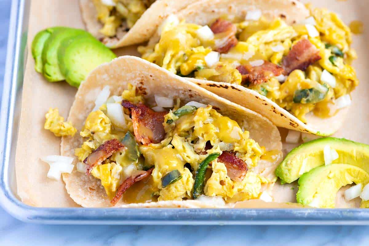These easy breakfast tacos with shredded potatoes, peppers and onions are ultra-satisfying, quick and delicious. You have just found your new favorite breakfast.