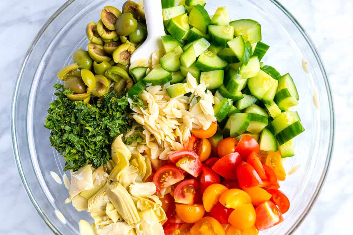 Everyone loves this easy orzo pasta salad recipe with a simple lemon vinaigrette, cucumber, olives, tomato and fresh herbs. Orzo Pasta Salad Ingredients