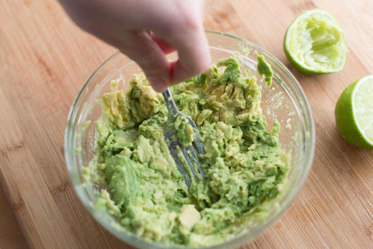 Mashing avocado with a fork