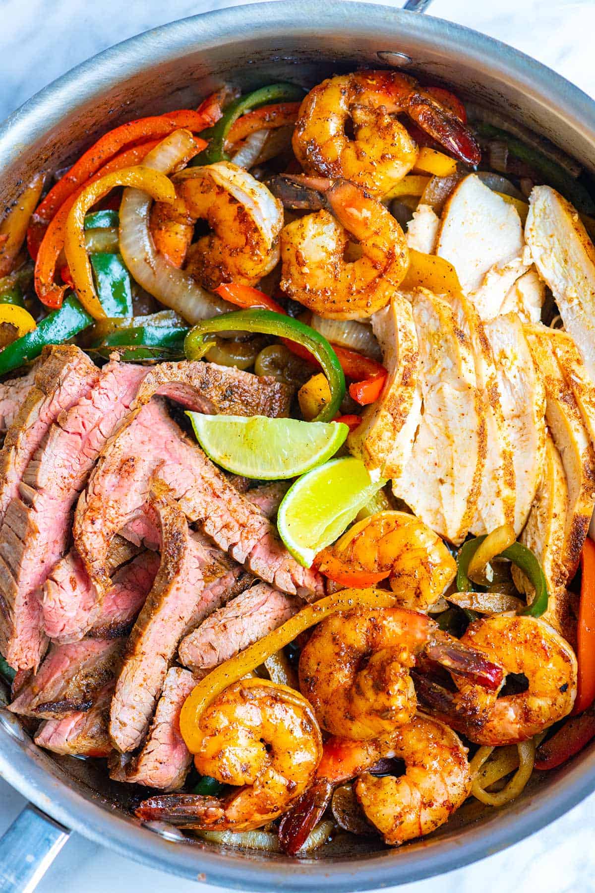 Steak, Chicken, and Shrimp fajitas cooked and ready to serve.