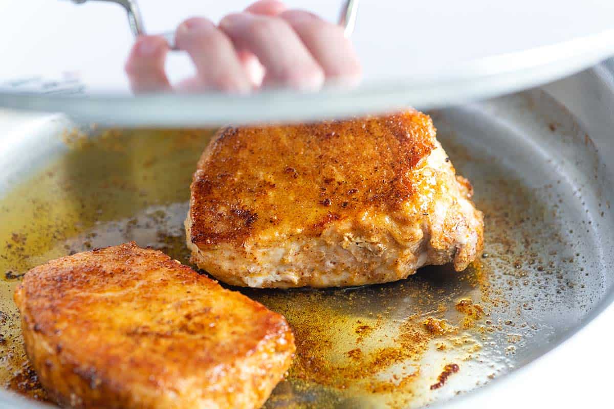 Sear pork chops on one side, flip then cover with a lid