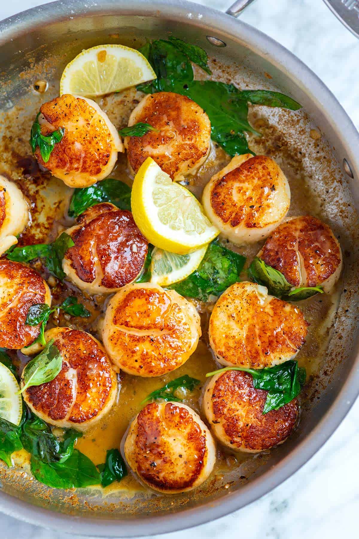 Pan-seared scallops with butter, lemon, and basil