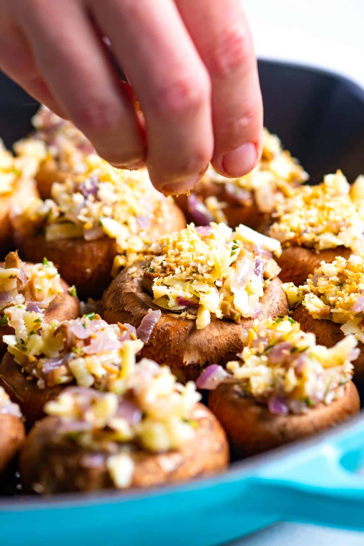 Adding the breadcrumbs to Vegetarian Stuffed Mushrooms 