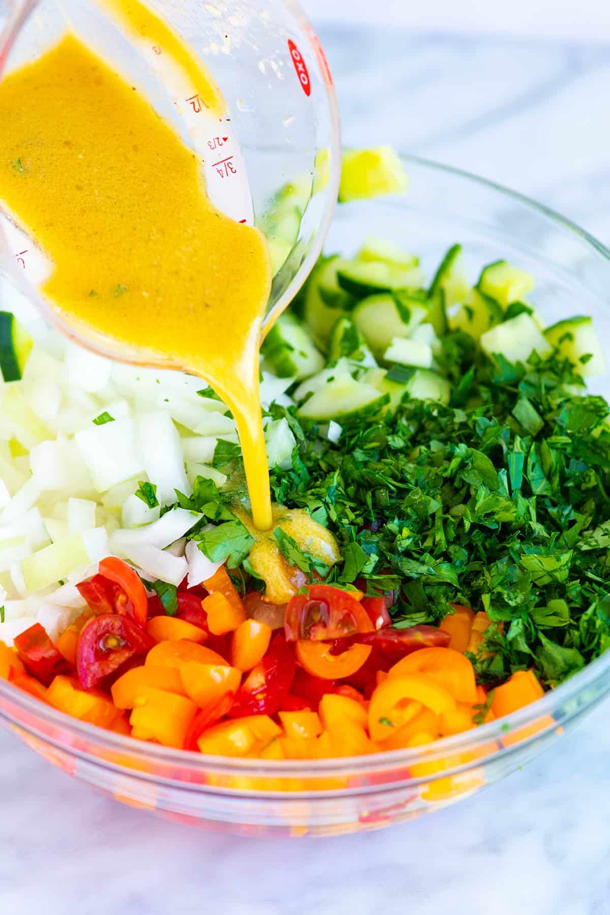 Making a Chopped Cucumber Tomato Onion Salad