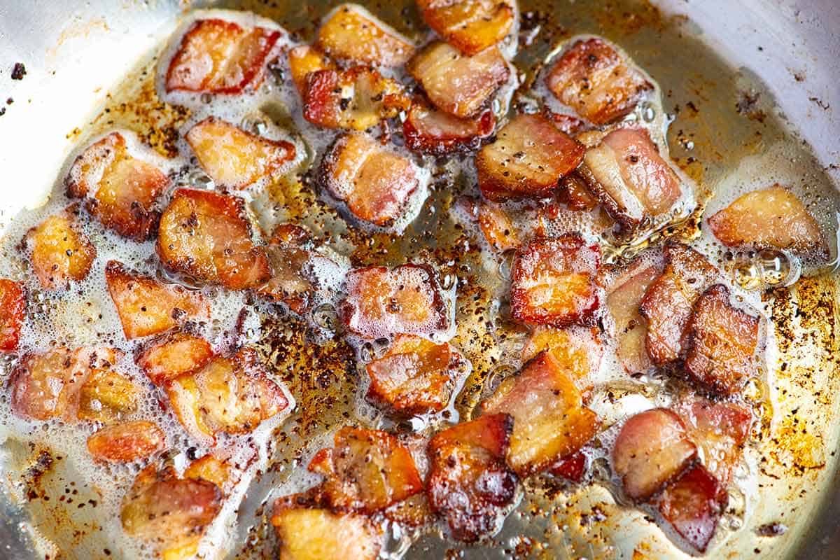 Bacon cooking in a pan for bacon fried cabbage