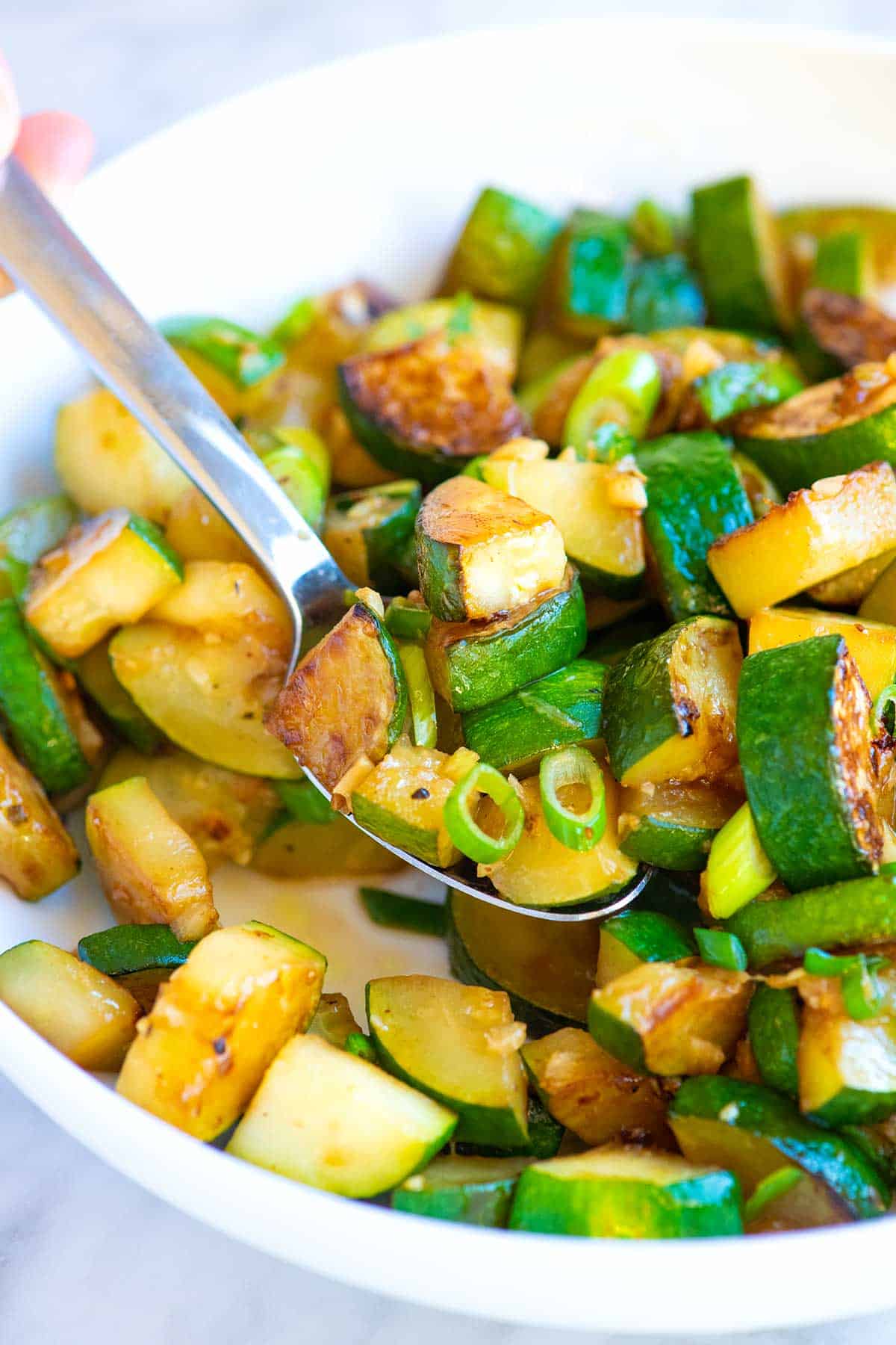 Golden brown zucchini that's been cooked on the stove (sautéed zucchini)